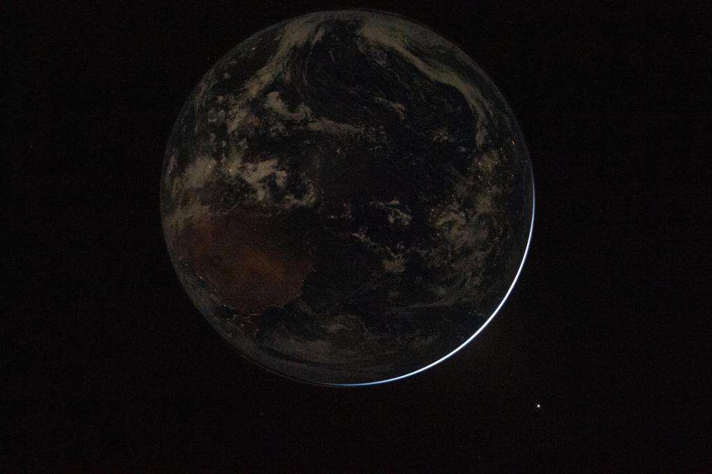 Artemis II Captures Dark Side of the Earth(April 3, 2026) - A view of a backlit Earth taken by NASA astronaut and Artemis II Commander Reid Wiseman from one of the Orion spacecraft's window after completing the translunar injection burn on April 2, 2026.
Image Credit: NASA
